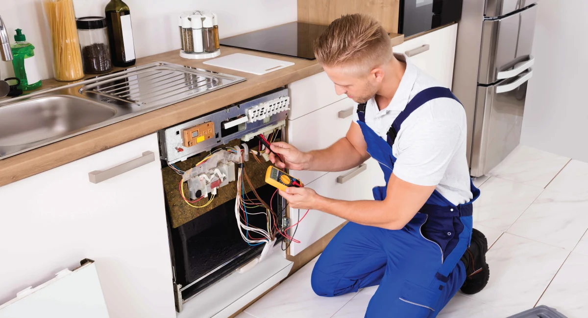 Technician testing the components of a built-in dishwasher